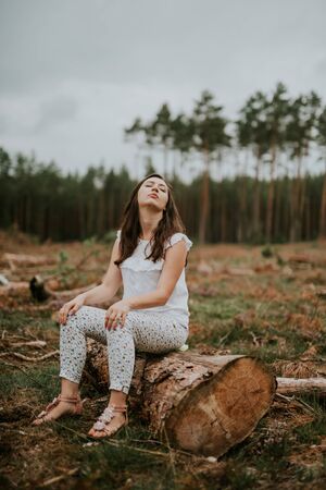a photo of woman in the forest where the purple heather blooms. copy space