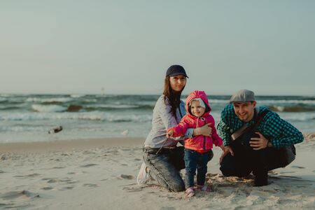 Happy mother, father and daughter in the park. Beauty nature scene with family outdoor lifestyle....