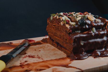 Chocolate cake with raisins lies on the tableの写真素材