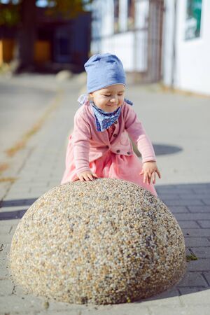Adorable girl having fun on beautiful autumn day. authentic childhood imageの写真素材