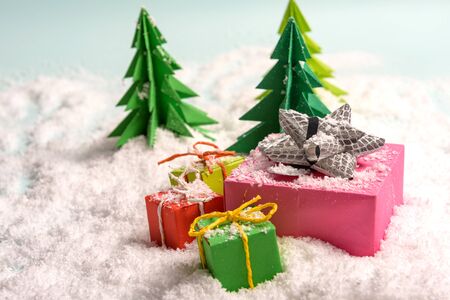 christmas presents nicely decorated with bows and feathers in snow. view from aboveの写真素材