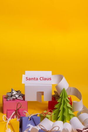 Long twisted expanded letter for Santa Claus. Copy space. yellow background. Santa Claus paper home at north pole.の写真素材