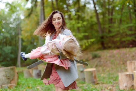 Beautiful little girl on a walk in the park on a sunny day. Autumn dayの写真素材