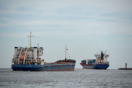 Transport vessels depart from the port in Swinoujscie to the open Baltic Seaの写真素材