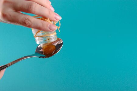 close up of honey jar on blue backgroundの写真素材