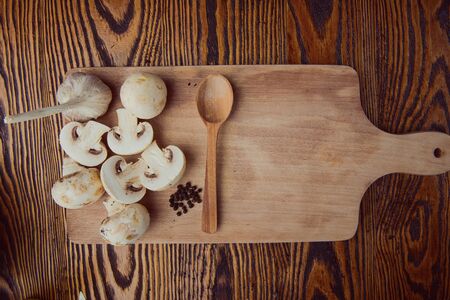 composition poured olive oil, mushrooms, garlic on wooden background. healthy foodの写真素材