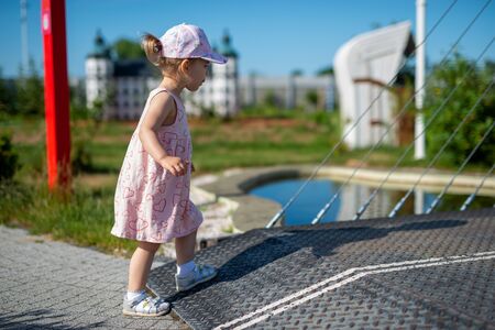 Little girl spending fantastic time on playground. Happy childhood. Authentic imageの写真素材