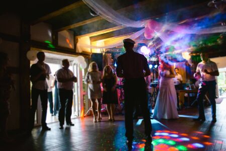 Bride and groom dancing the first dance at their wedding day. Guest on the dancefloorの写真素材