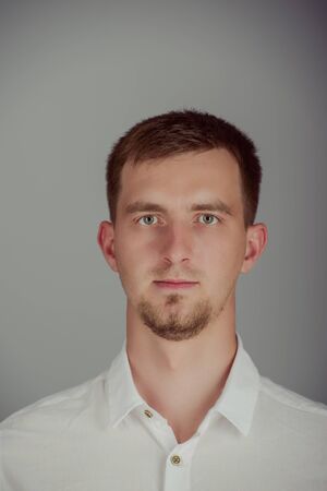 Portrait of a smiling young brunette man in studioの写真素材