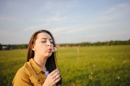 Happy young girl enjoying the beauty of sunny spring day.の写真素材