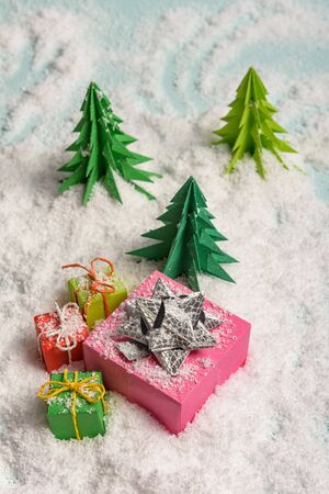 christmas presents nicely decorated with bows and feathers in snow. view from aboveの写真素材