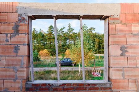 Interior of a Unfinished Red Brick House Walls under Construction without Roofing.の写真素材