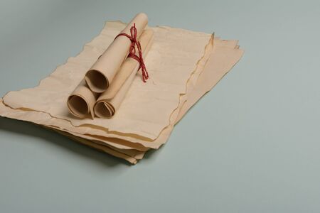 Raven feather, inkwell and old yellowed paper on red background. Copy space. Old letter.の写真素材