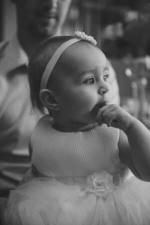 Baby girl 1 year old eating birthday cake in room. Birthday party. Childhood.の写真素材