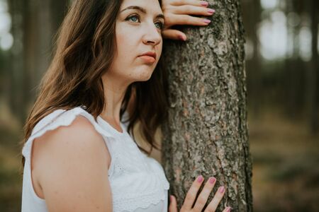 Woman in the forest where the purple heather blooms. copy space. Authentic lifestyle imageの写真素材