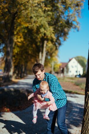 Happy loving family. Father and his daughter child girl playing and hugging outdoors. Authentic lifestyle. Concept of Father's day.の写真素材
