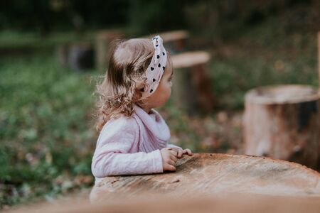 beautiful little girl smiling on a sunny day. Blue eyes. head shot.の写真素材