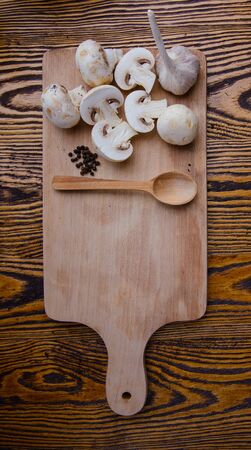composition poured olive oil, mushrooms, garlic on wooden background. healthy foodの写真素材