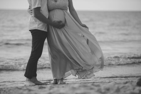 Bride and groom at a photo session in the nature. Baltic sea beach.