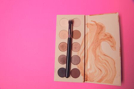 Palette of colorful eye shadows. Pink background.の写真素材