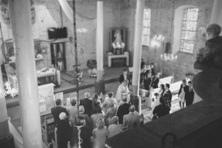 Bride and groom at church wedding during ceremony. Beautiful decorationの写真素材