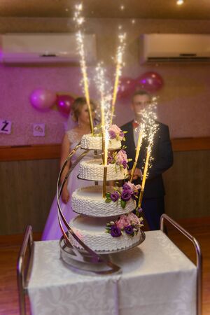 Delicious Wedding Cake at the party. Smoke and fire effectsの写真素材