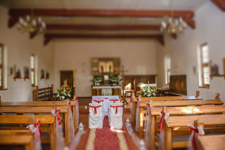 Church sanctuary before a wedding ceremony. Empty chairs for bride and groomのeditorial素材