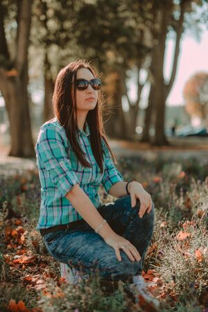 Autumn attractive woman portrait smiling outdoors at the park. Authentic and natural photographsの写真素材