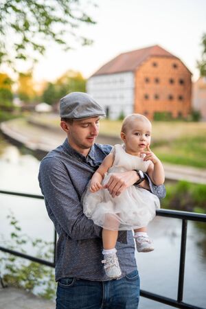 Happy loving family. Father and his daughter child girl playing and hugging outdoors. Cute little girl hugs daddy. Concept of Father's day.の写真素材