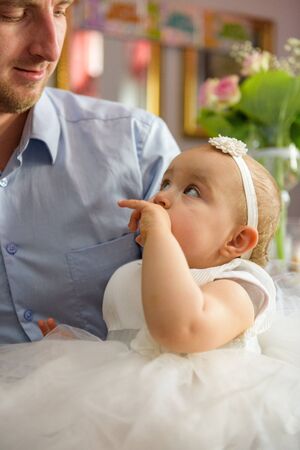 Baby girl 1 year old eating birthday cake in room. Birthday party. Childhood.の写真素材
