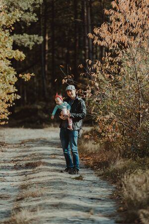 Happy loving family. Father and his daughter child girl playing and hugging outdoors. Cute little girl hugs daddy. Concept of Father's day.の写真素材