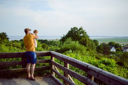 Happy loving family. Father and his daughter child girl playing and hugging outdoors. Cute little girl hugs daddy. Concept of Father's day.の写真素材