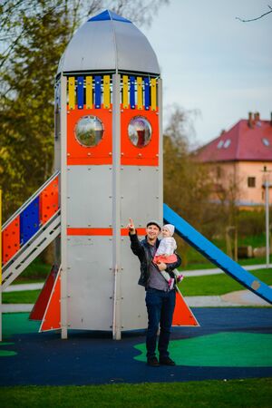 Happy loving family. Father and his daughter child girl playing and hugging outdoors. Cute little girl hugs daddy. Concept of Father's day.の写真素材