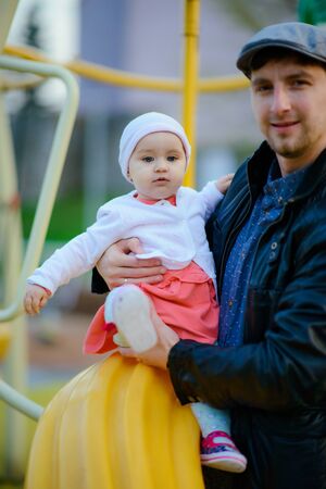 Happy loving family. Father and his daughter child girl playing and hugging outdoors. Cute little girl hugs daddy. Concept of Father's day.の写真素材