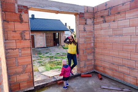 Interior of a Unfinished Red Brick House Walls under Construction without Roofing.の写真素材