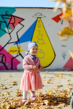 Adorable girl having fun on beautiful autumn day.の写真素材
