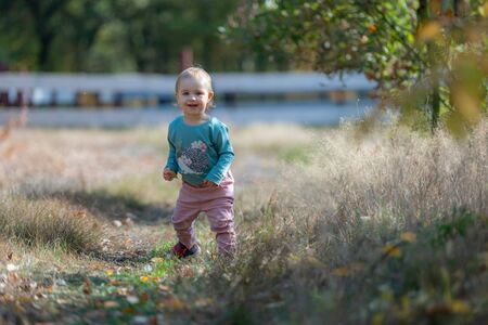 Adorable girl having fun on beautiful autumn day.の写真素材