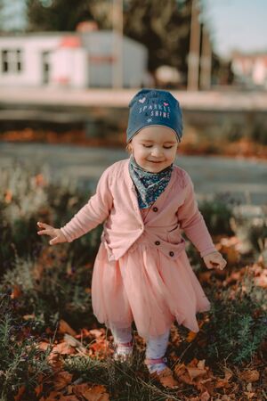Adorable girl having fun on beautiful autumn day.の写真素材