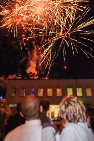 Wedding couple and fireworks, Bride, groom and wedding guests watching fireworks displayの写真素材