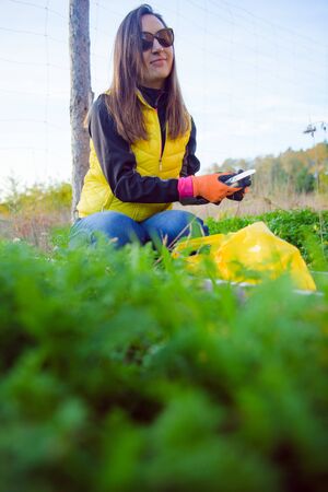 Farmer holds carrots in his hands. Collecting harvest: orange carrot in hands of female farmer. Close-up of carrots harvested from the garden. Concept of healthy eating.の写真素材