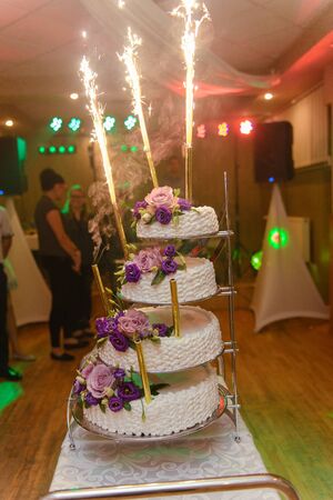 Delicious Wedding Cake at the party. Smoke and fire effectsの写真素材