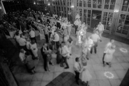 Bride and groom dancing the first dance at their wedding day. Guest on the dancefloorの写真素材