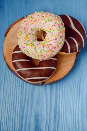 donuts lying on the table. blue background.の写真素材