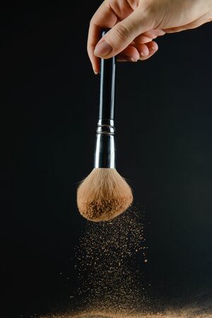 close up of a make up powder and a brush. makeup brush with powder foundationの写真素材