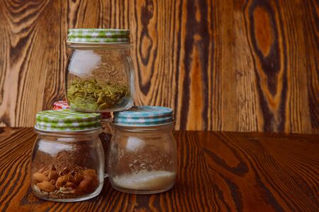 Almonds in a jar on the blue wooden table.の写真素材