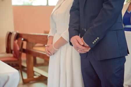Bride and groom at church wedding during ceremony. Beautiful decorationの写真素材