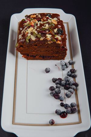 Chocolate cake with raisins lies on the tableの写真素材