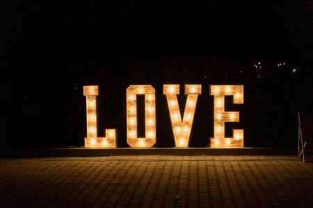 Illuminated Love sign in large letters at a wedding reception.の写真素材