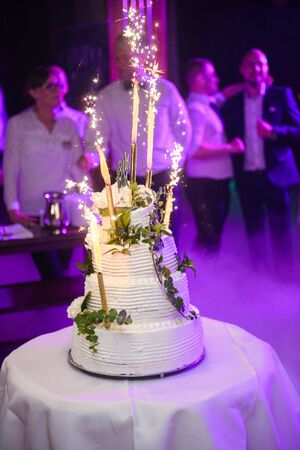 Delicious Wedding Cake at the party. Smoke and fire effectsの写真素材