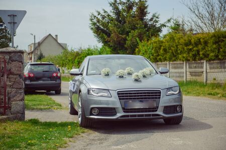 Luxury wedding car decorated with beautiful flowers. Brides and grooms wedding dayの写真素材